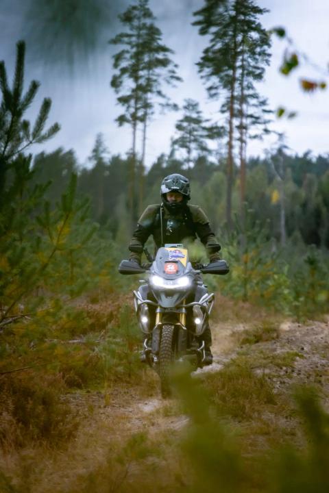 A motorcycle rider travelling along a sandy forest trail – Alakonnu Rally 2025