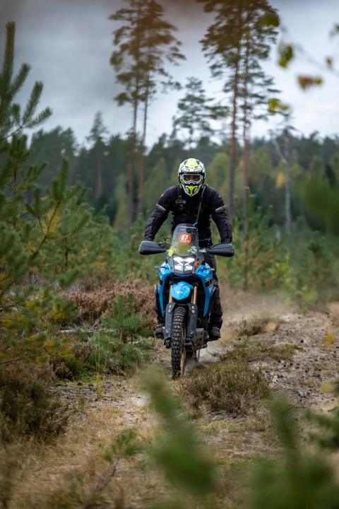 A motorcycle rider travelling along a sandy forest trail – Alakonnu Rally 2025