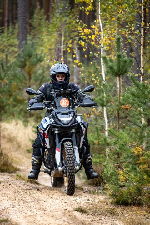 A motorcycle rider travelling along a sandy forest trail – Alakonnu Rally 2025