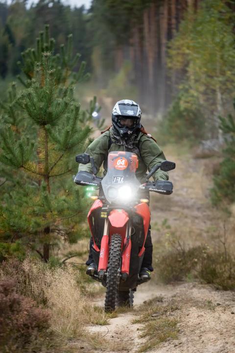 A motorcycle rider travelling along a sandy forest trail – Alakonnu Rally 2025