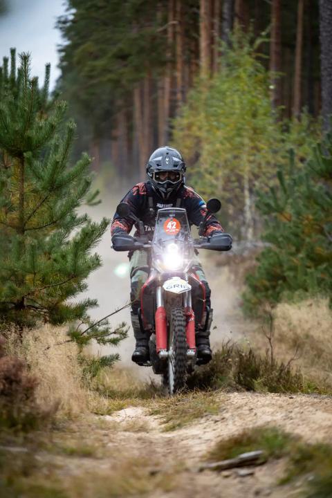 A motorcycle rider travelling along a sandy forest trail – Alakonnu Rally 2025