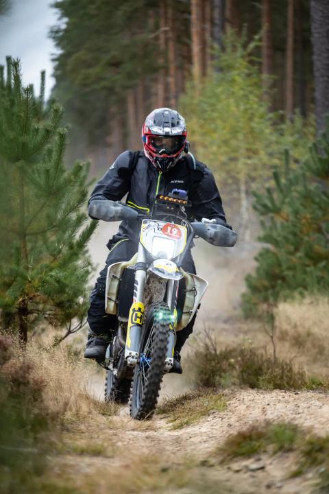 A motorcycle rider travelling along a sandy forest trail – Alakonnu Rally 2025