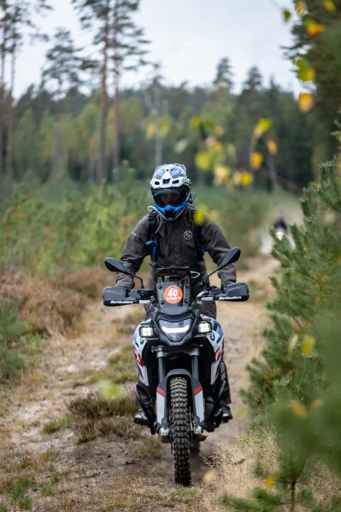 A motorcycle rider travelling along a sandy forest trail – Alakonnu Rally 2025