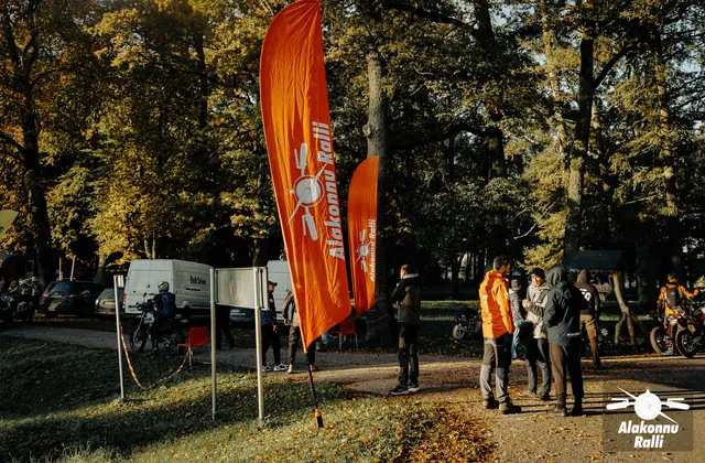 An organizer waiting for motorcycle riders beside the rally flag – Alakonnu Rally 2026, SS2 · SS3